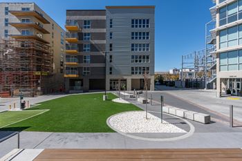 A modern building with a grassy area in front.